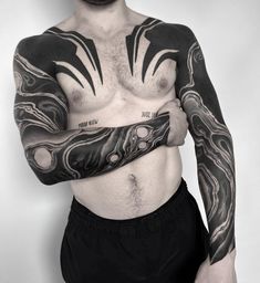 a man with tattoos on his arms and chest