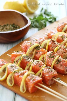 the skewers are covered with salmon and herbs