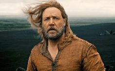 a man with long hair and beard standing in front of the ocean saying, flooding? i noah guy