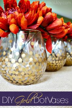 three silver vases with red flowers in them