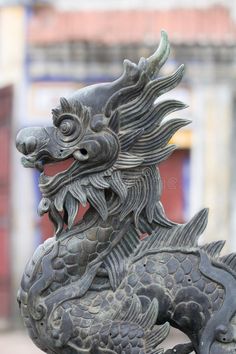 a statue of a dragon on top of a building