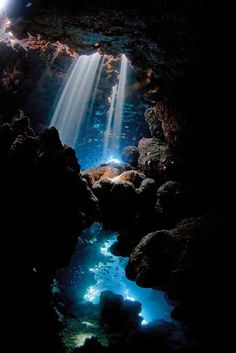 the light shines brightly through the water in this cave