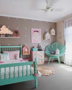 a child's bedroom decorated in pastel colors