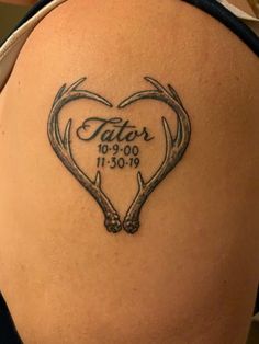 the back of a woman's thigh with antlers and date tattooed on it