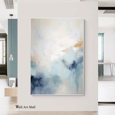 an abstract painting hanging on the wall in a room