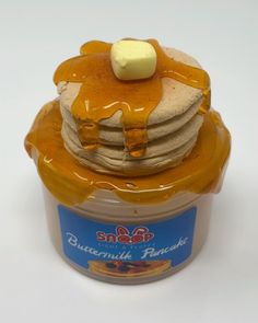 a stack of pancakes in a jar with butter on top