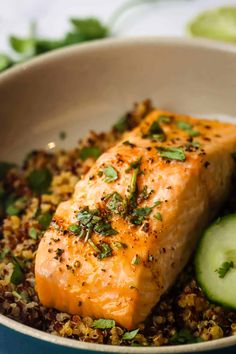 salmon and couscous in a bowl with cucumbers