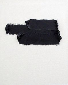 two pieces of black paint on a white wall