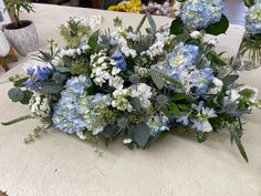 a bouquet of blue and white flowers on a table