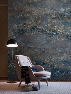 an image of a chair in front of a wall with stars on it and a lamp next to it