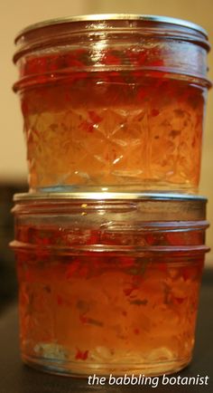 three jars filled with food sitting on top of a table