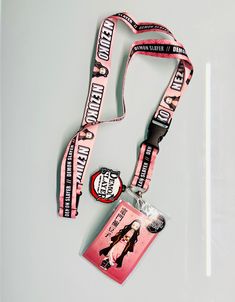 a lanyard with a badge attached to it on a white surface next to a pair of scissors