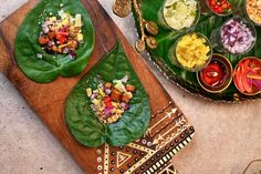 two plates filled with food on top of a wooden cutting board