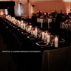 the long table is set with candles and place settings for guests to sit down at