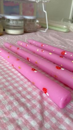 three pink candles sitting on top of a table