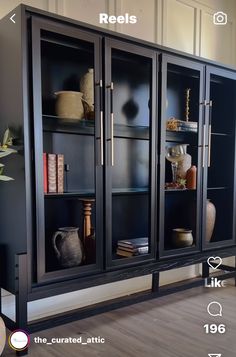 a black bookcase with glass doors and shelves