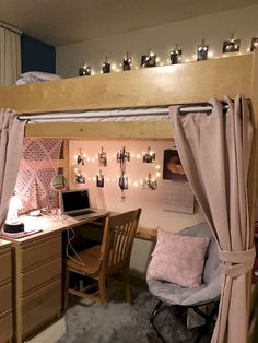 a loft bed with a desk and chair underneath it, surrounded by string lights on the ceiling