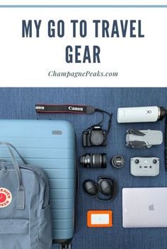 the contents of a travel gear bag, camera, laptop and other items laid out