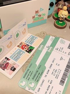 an open ticket sitting on top of a table next to toy figurines and other items