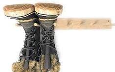 pair of black boots hanging on wooden pole