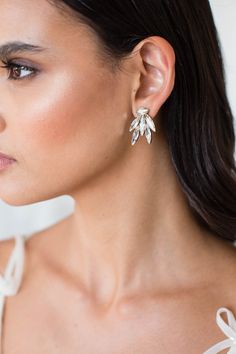 a close up of a person wearing some kind of earring with flowers on it