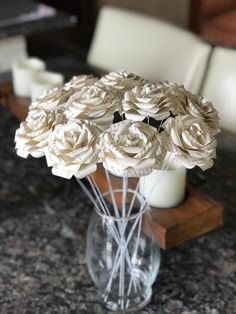 a vase filled with white flowers on top of a table