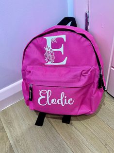 Step into style with our charming Personalized Pink Backpack, a perfect blend of function and flair for school, work, or daily adventures! This gorgeous backpack features your initial in a stunning, large floral font, beautifully complemented by your  name underneath, creating a truly unique and personal touch. Features: Color: Vibrant Pink Material: Durable, high-quality polyester fabric that's easy to clean and built to last. Dimensions: 33cm x 24cm  x 17cm, ideal for everyday essentials. Pers Pink Satchel For Back To School, Pink School Satchel, Pink Letter Print Backpack For Everyday Use, Personalized Travel Bags For Back To School, Personalized Everyday Backpack, Personalized Standard Backpack For Daily Use, Personalized Standard Backpack, Personalized Pink Everyday Backpack, Personalized Backpack For Students