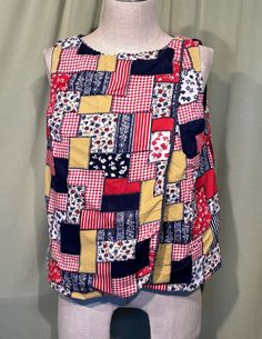 a mannequin wearing a colorful patchwork top