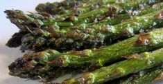 asparagus with brown sauce on a white plate