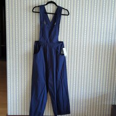 Urban Outfitters Navy Overalls Jumpsuit Wide Leg. Straps Have Adjustable Buttons. Nwt. Size: M Blue Bib Front Jumpsuit With Pockets, Blue Bib Front Jumpsuits And Rompers With Pockets, Blue Bib Front Jumpsuit For Workwear, Blue Bib Front Jumpsuits And Rompers For Work, Sleeveless Blue Overalls For Workwear, Navy Jumpsuits And Rompers With Pockets For Spring, Spring Navy Jumpsuits And Rompers With Pockets, Urban Outfitters Fitted Cotton Jumpsuits And Rompers, Fitted Cotton Jumpsuits And Rompers By Urban Outfitters