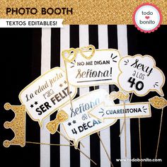 some white and gold signs are in front of a black and white striped background with the words photo booth on it