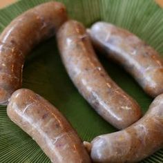 three sausages are on a green cloth