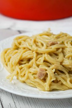 a white plate topped with pasta and meat