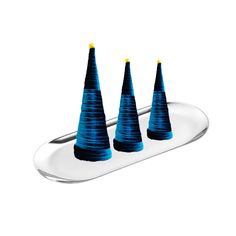 three blue cones sitting on top of a metal tray next to each other in front of a white background