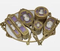 an ornate set of four photo frames with purple and gold trim