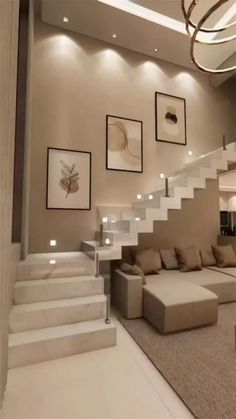 a living room filled with lots of furniture and pictures on the wall above it's stairs