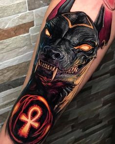 a man with a tattoo on his arm that has an image of a demon in it