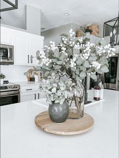 a vase filled with flowers sitting on top of a counter