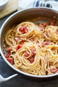 a pan filled with pasta and sauce on top of a table