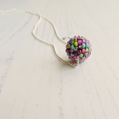 Droplette  ~ handmade artisan bead ball chain necklace in a purple, aqua and green - glass and sterling silver  I have had these necklaces at my in-person events for a couple of years now, but am only just now getting around to sharing them here! The perfect complement to my handwoven glass studs and drop earrings, these simple, delicate pendants are the perfect everyday necklace - just a drop of colour on a delicate chain, throw one on to coordinate with whatever your colour mood is for the day Purple Tiny Beads Necklace As Gift, Purple Tiny Beads Necklace Gift, Purple Necklaces With Tiny Beads As Gift, Purple Necklace With Tiny Beads Gift, Beaded Chain Pendant For Jewelry Making, Colorful Beaded Pendant Jewelry, Multicolor Beaded Chain Necklace With Round Pendant, Minimalist Jewelry With Ball Chain And Round Pendant, Multicolor Round Pendant Necklace With Beaded Chain