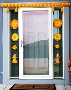 the front door is decorated with yellow flowers and tassels for decoration on it