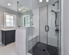 a bathroom with a walk in shower next to a sink