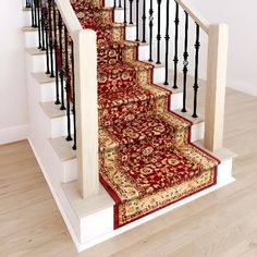 a staircase with red carpet and black railings