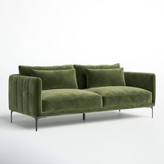 a green couch with two pillows on the back and one arm resting on it's side