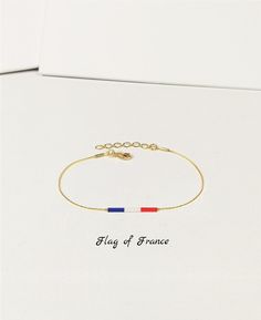 Subtle and minimalistic bracelet with the colors of French flag. Perfect gift for congrats on new citizenship.    This listing is for one bracelet. The 1st image shows the bracelet with the flag of FRANCE. Bracelets with the flag colors of many countries, territories, regions, cities, universities, colleges, parties, communities, etc. are also available. Please ask us if this is possible before ordering. The chain, spacer beads and closure are available in gold tone (default) or silver tone (by White Bracelets For Independence Day Gift, Independence Day White Bracelets Gift, Minimalistic Bracelet, Flag Of France, France Flag, Japanese Colors, French Flag, New Country, Minimalist Bracelet