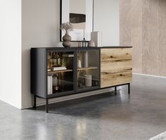 a modern sideboard with glass doors and wooden drawers in an empty living room area