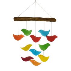 a colorful wind chime hanging from a wooden branch with birds on it's sides