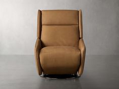 a brown recliner chair sitting on top of a gray floor