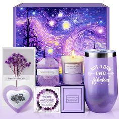 a purple gift box containing a candle, greeting cards and a heart