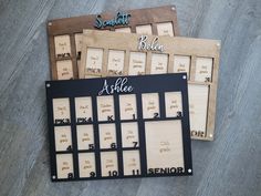 three wooden calendars sitting on top of each other with names and numbers in them